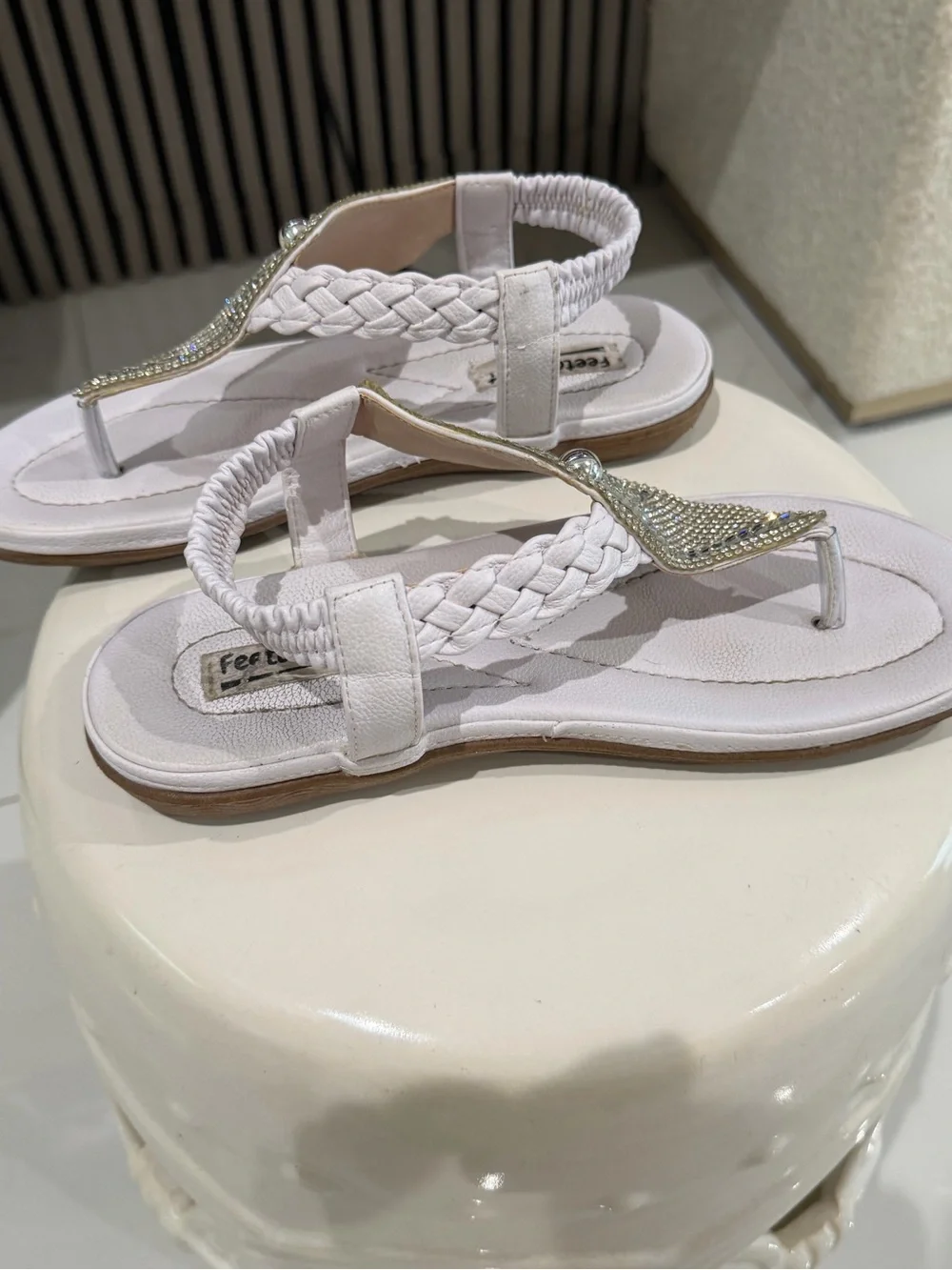 White rhinestone sandals with braided straps.